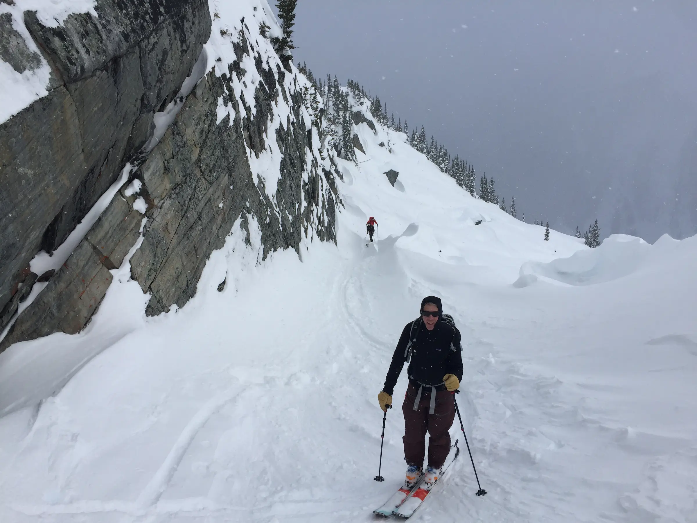 Skinning next to a rock wall, Rogers Pass.