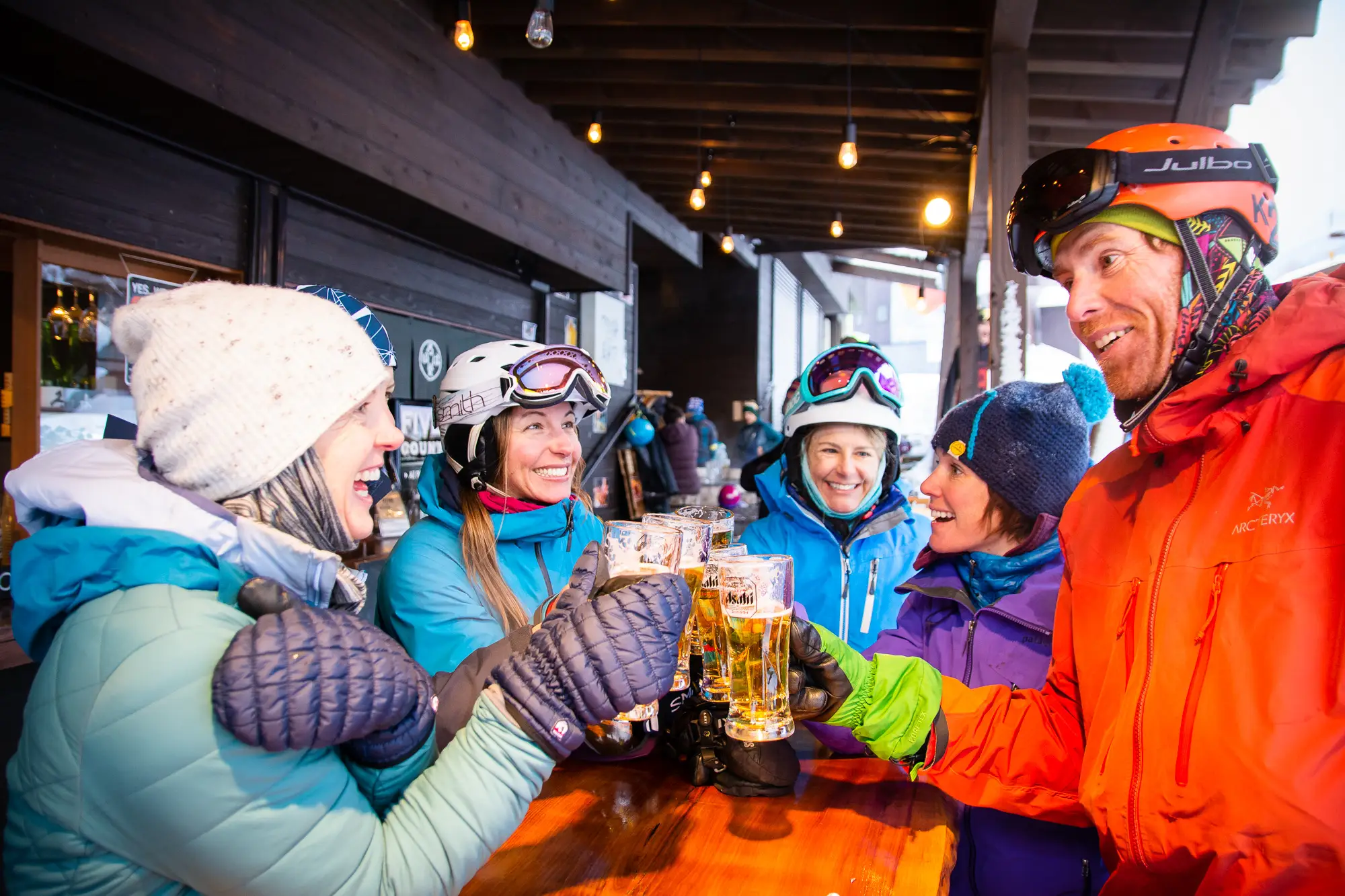 Will guide cheers with four women clients at outdoor bar Japan