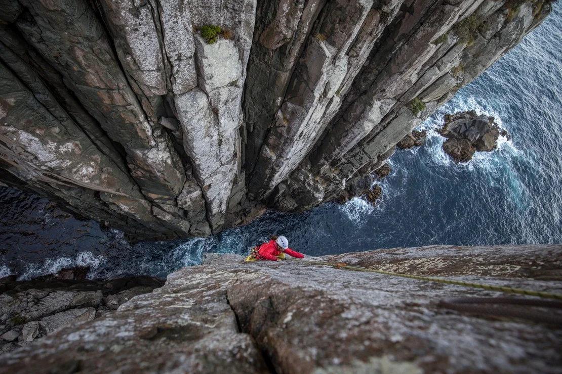 Sea stake climbing with the ocean below.
