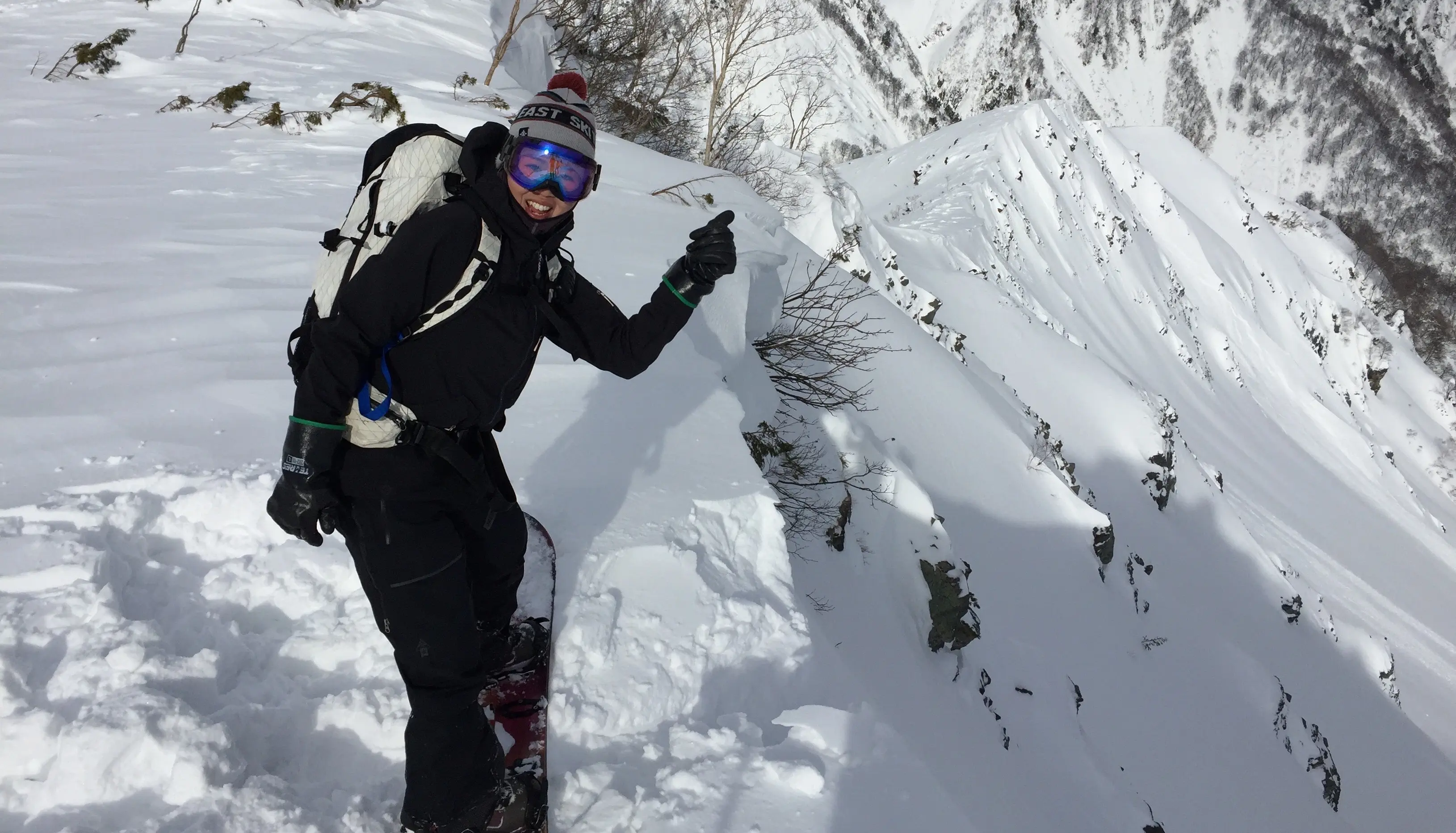 Japanese Snowboard waving, about to drop in
