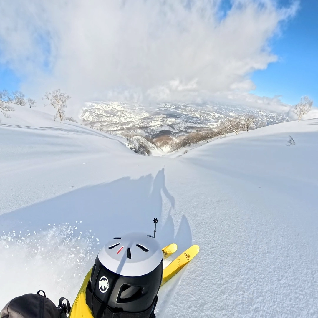 POV skier skinning down a perfect powder slope