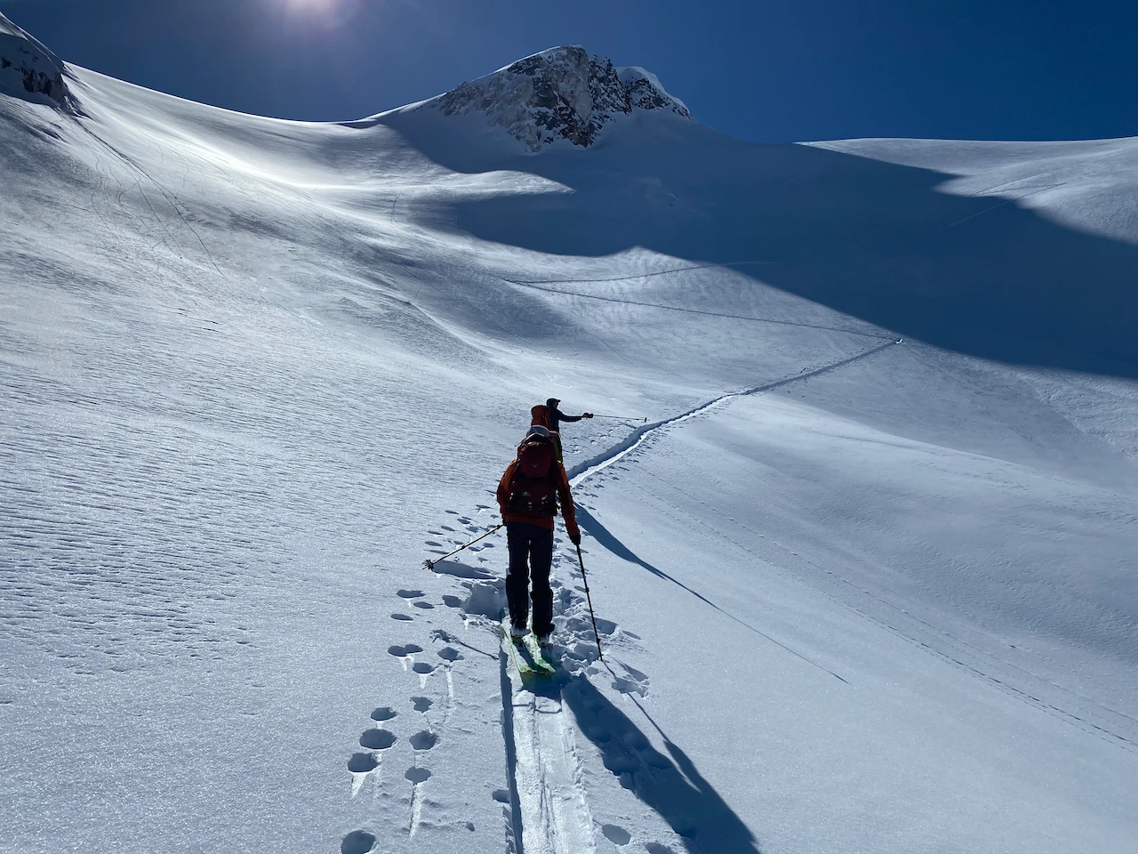 Two people on a skin track in alpine terrian
