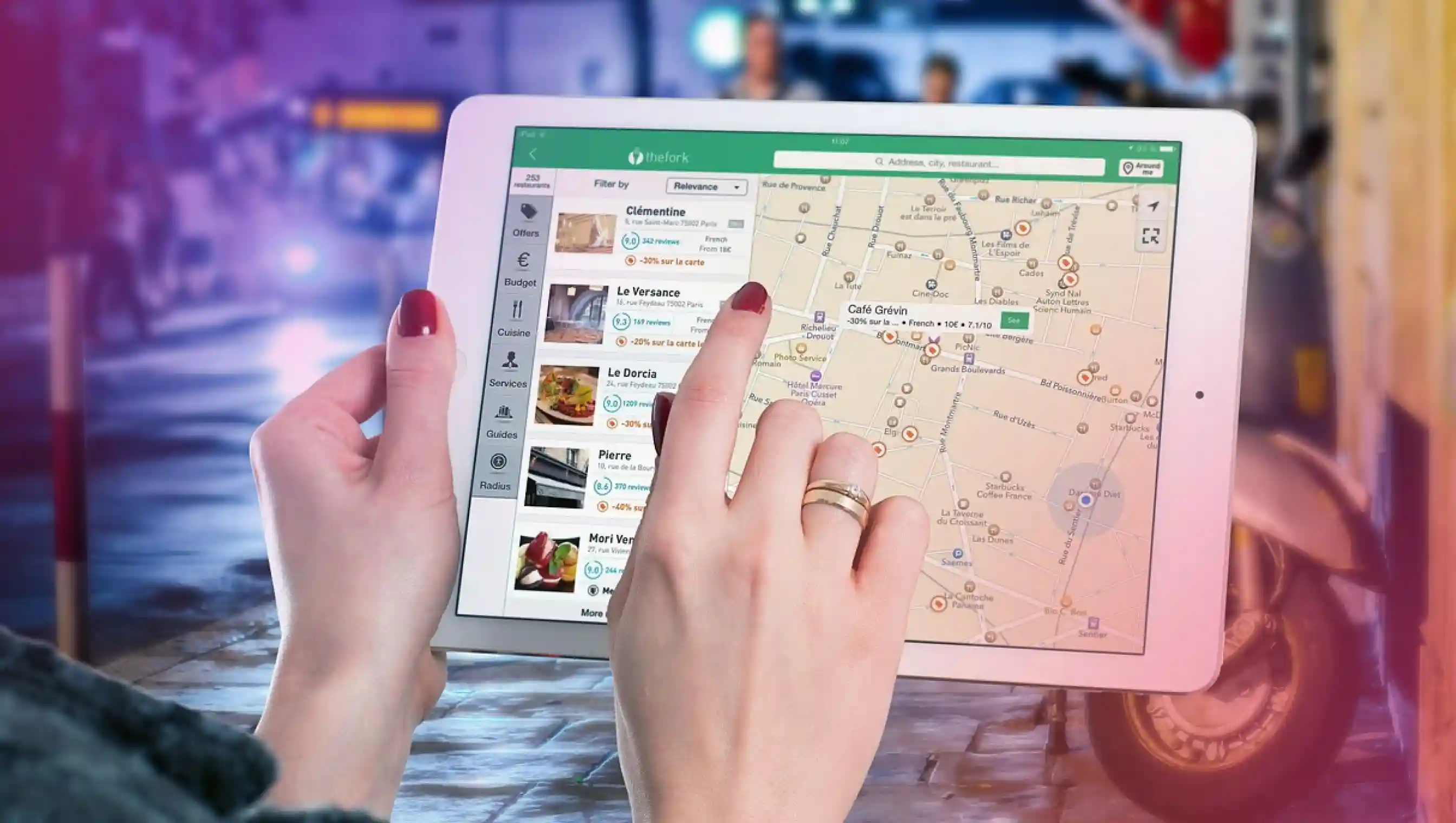 An image of a woman checking out various location on Apple maps, on an iPad