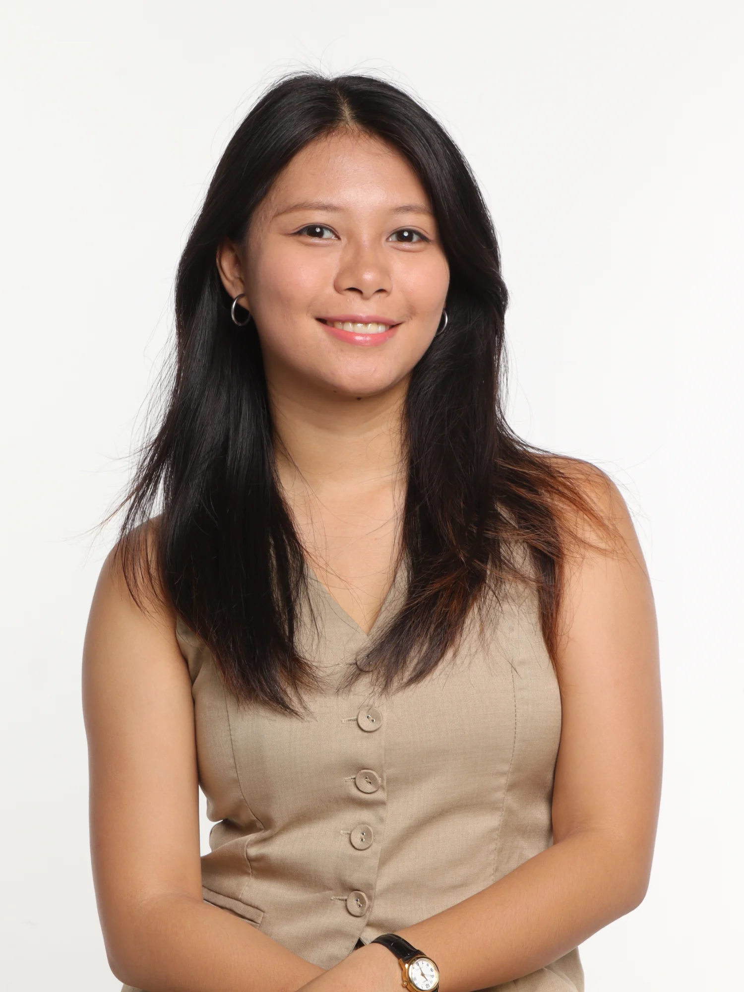 A portrait photograph of a woman with dark hair wearing a beige dress