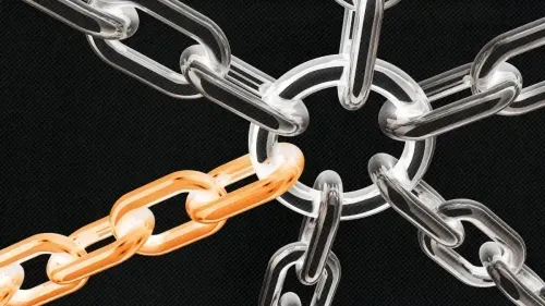 Close-up of transparent chain links connected to a central ring with one gold-colored chain link among them.