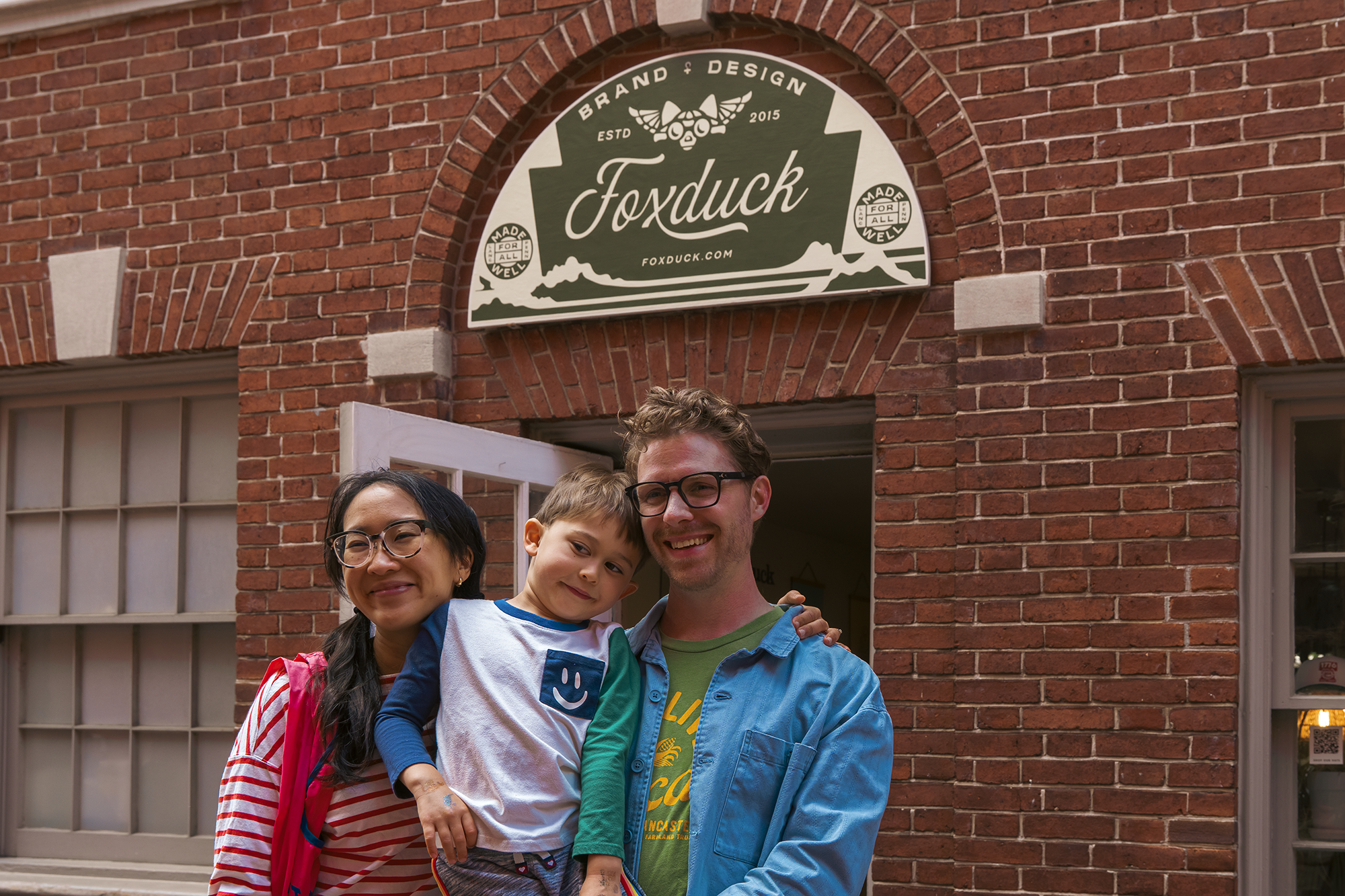 Happy customers smiling outside Foxduck shop