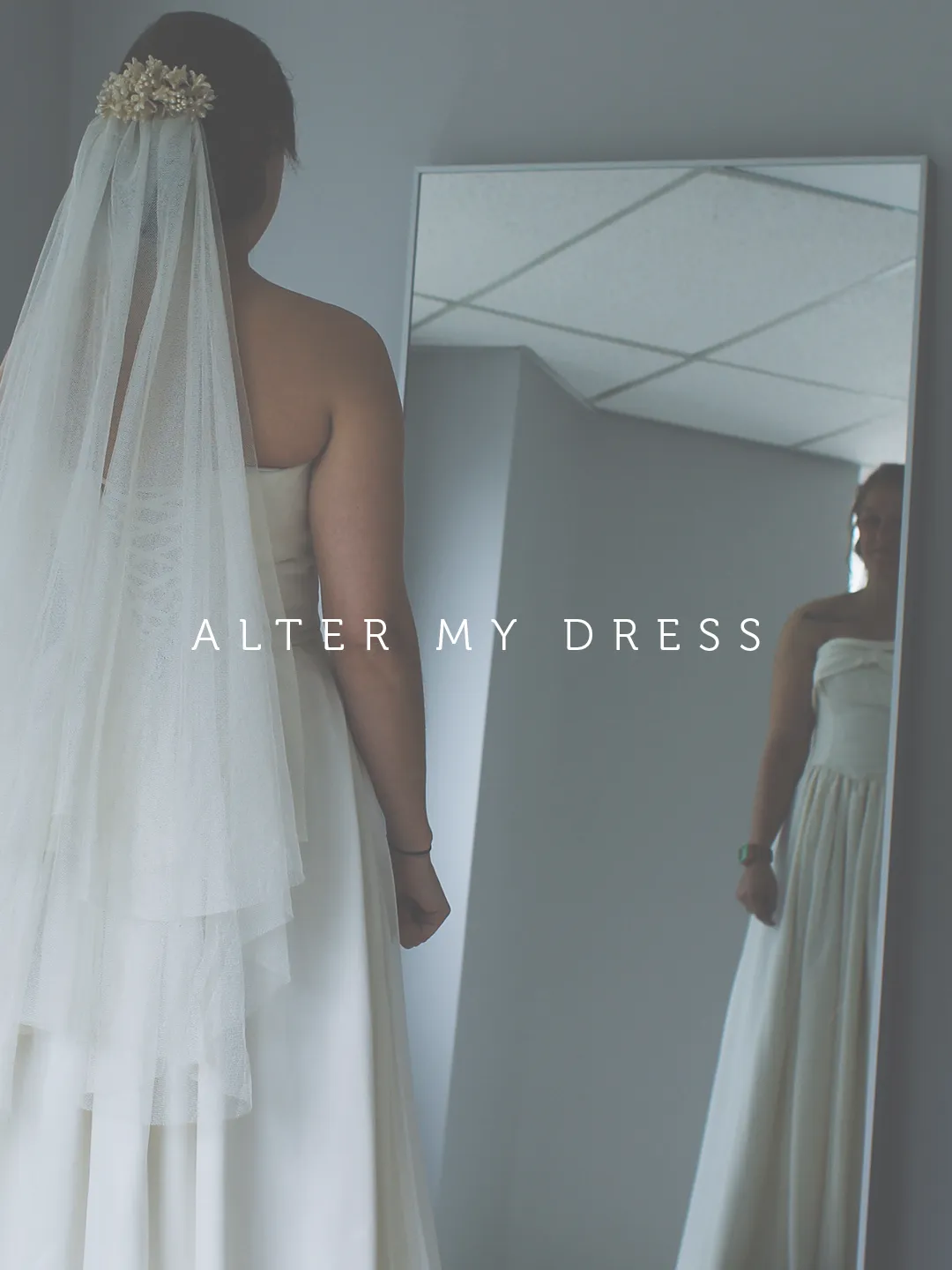 Alter My Dress Philly bride at a fitting standing in front of mirror