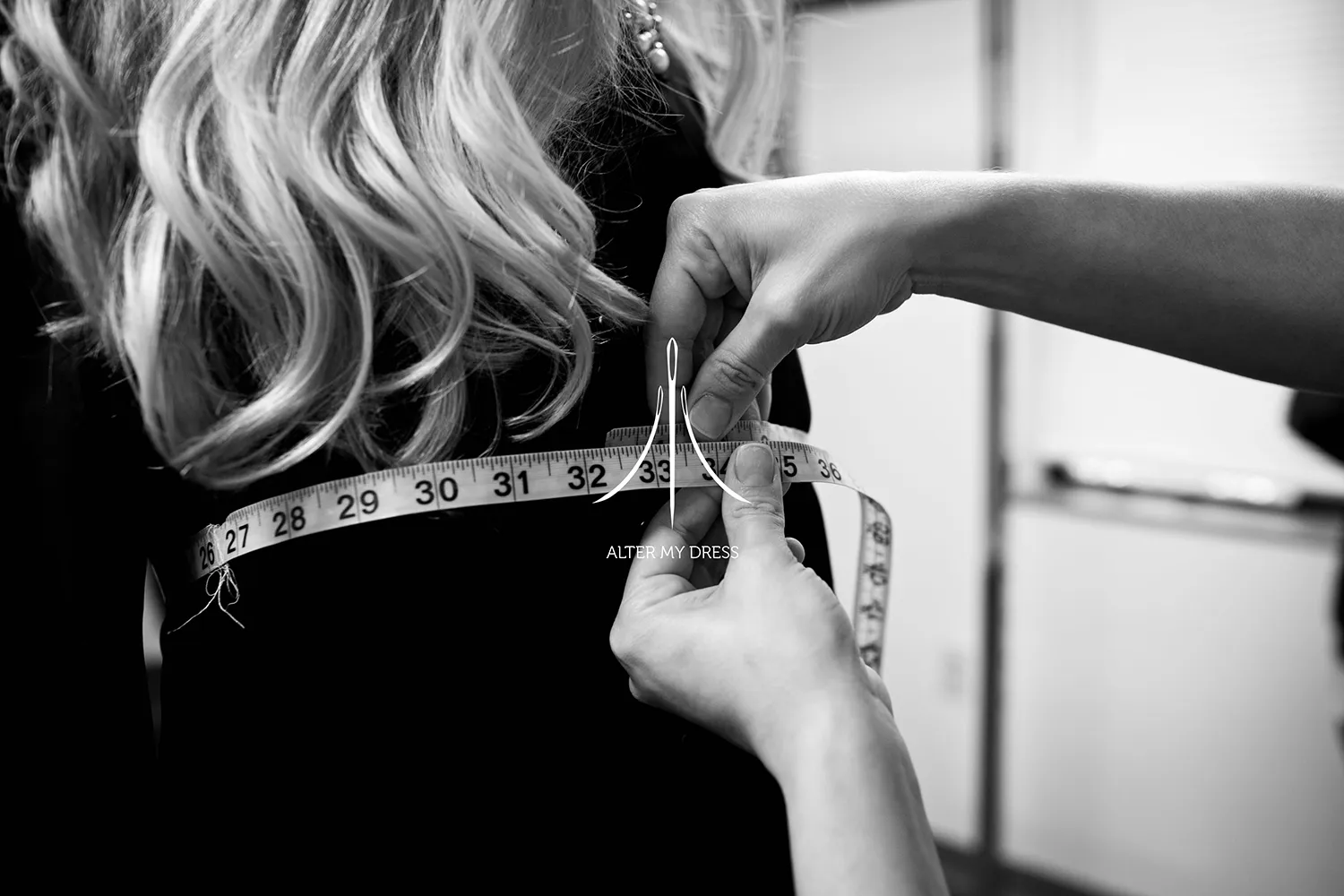 Alter My Dress wedding dress alterations fitting session with lead designer Priscilla measuring bride