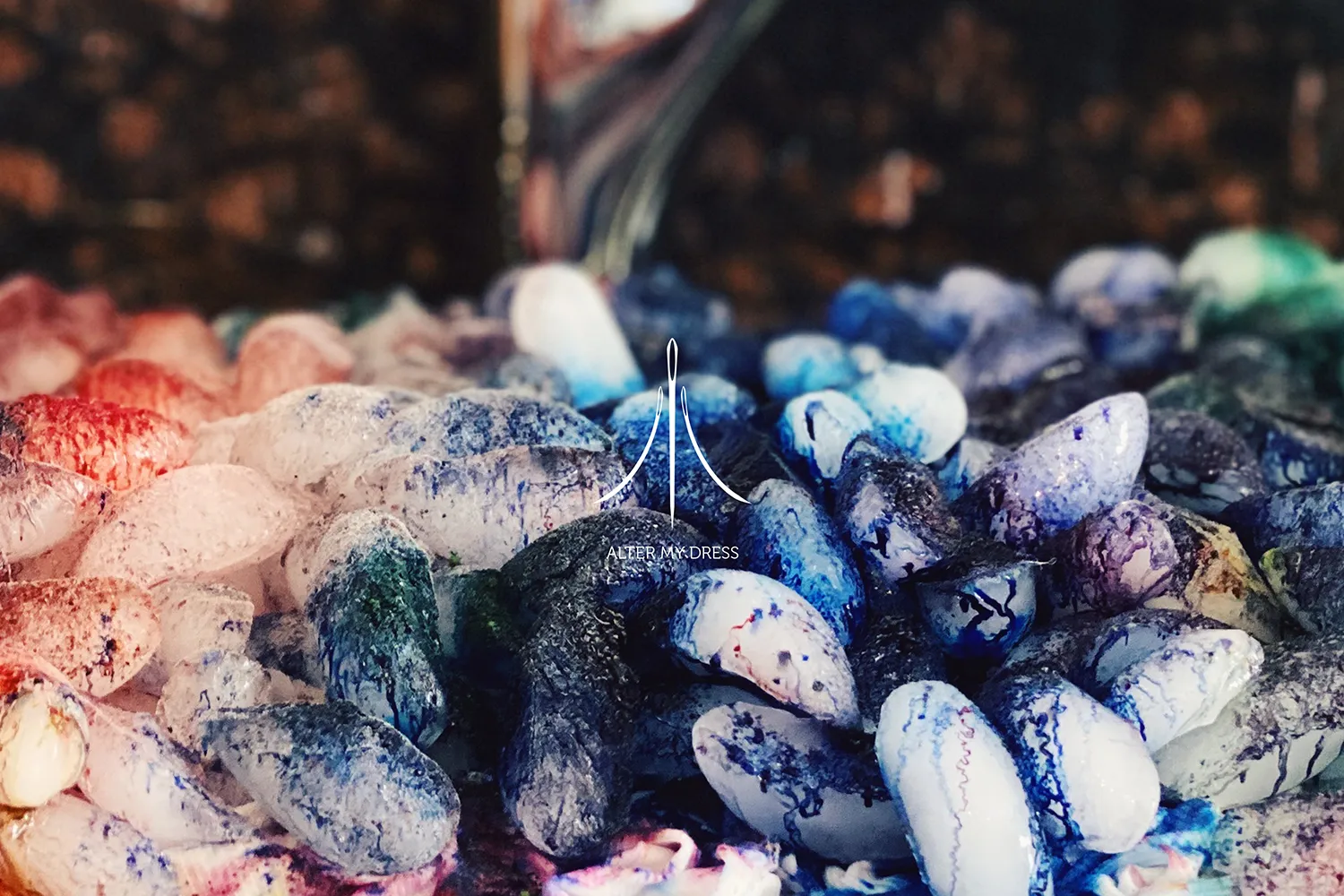 Cooling rack with ice chunks covered in a gradient of yellow to brown powder and plastic wrap on the right side.