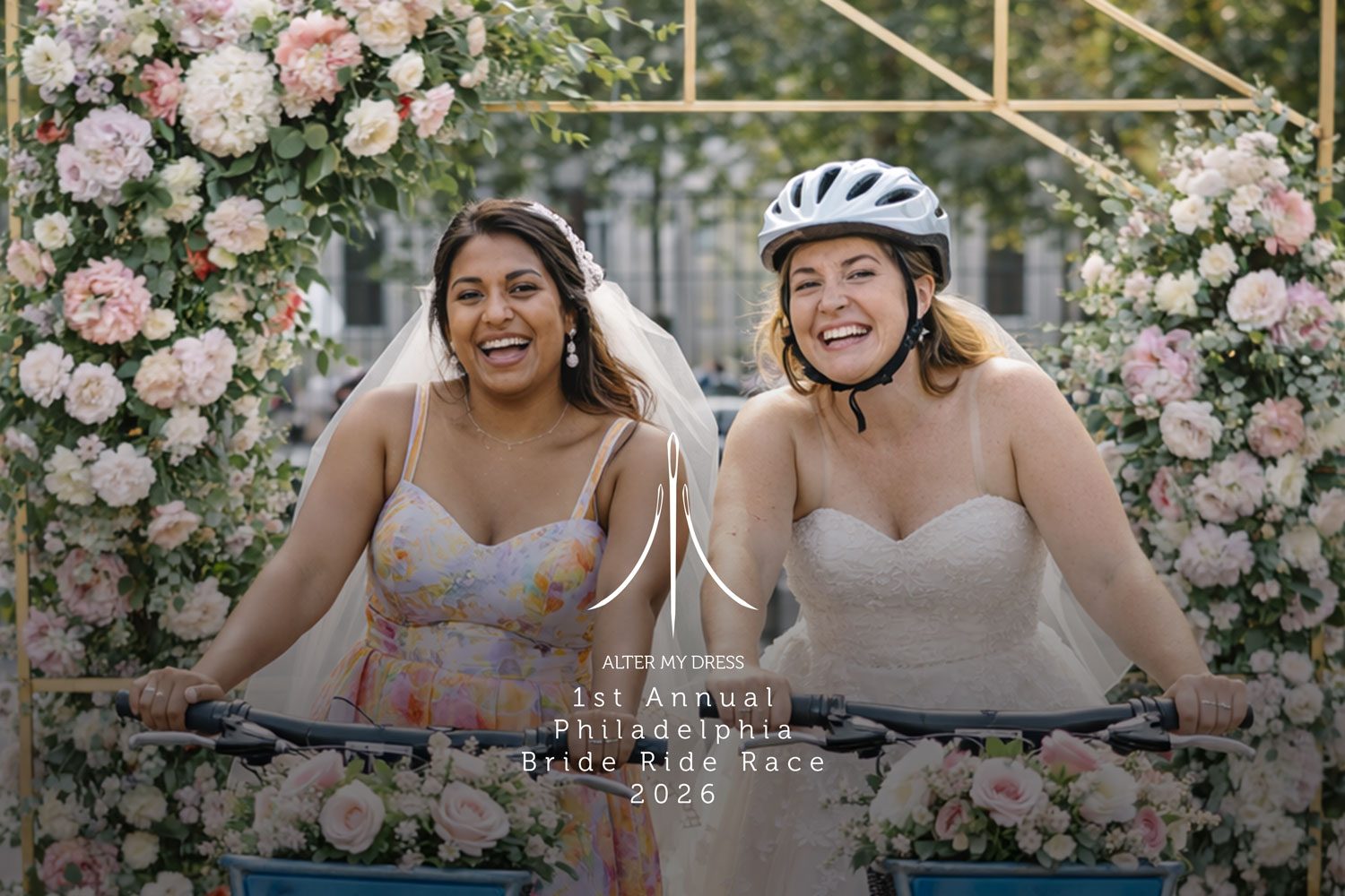 Two brides smiling on bicycles decorated with flowers, surrounded by floral arch, at the 1st Annual Philadelphia Bride Ride Race 2026.