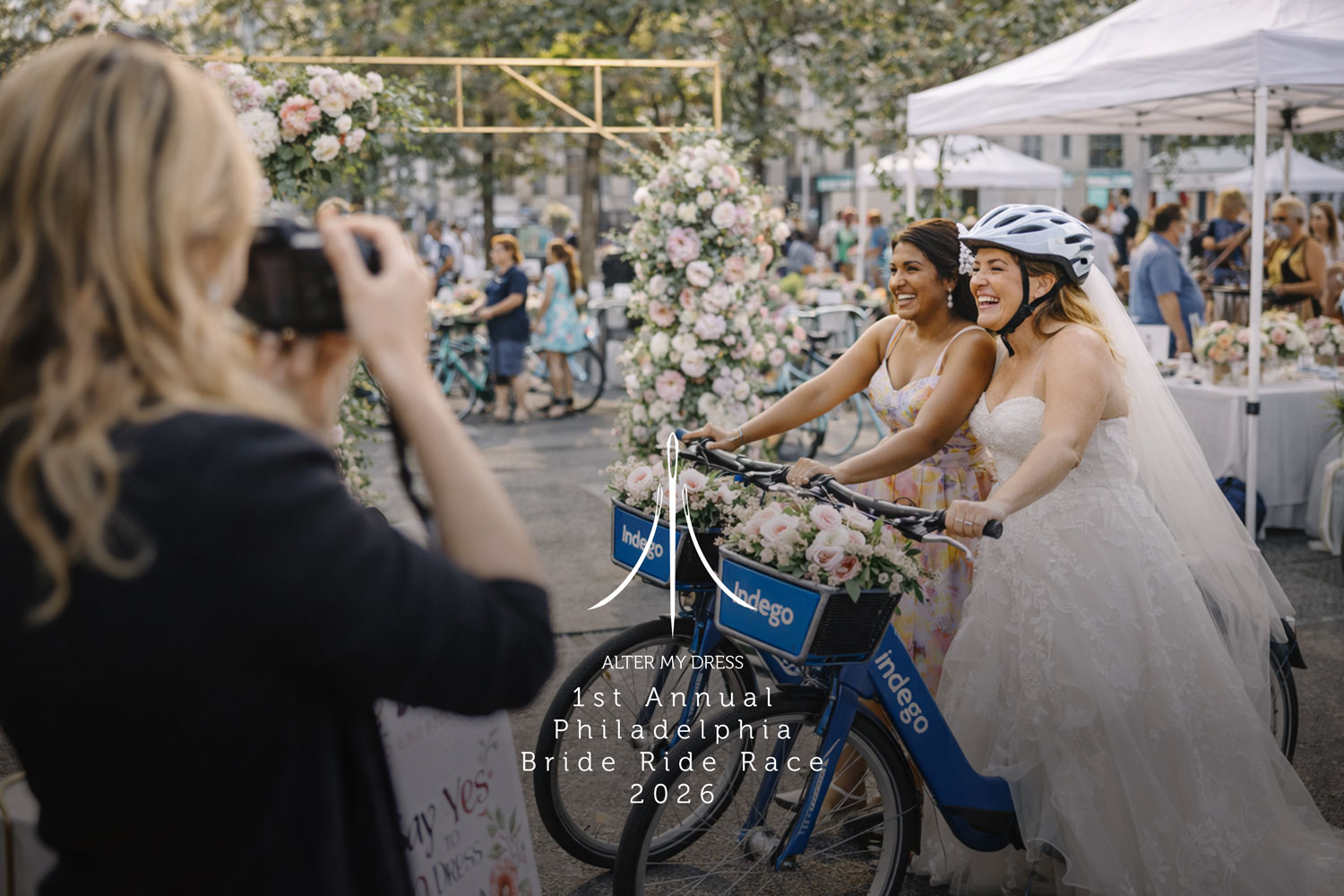 Two women smiling and posing with decorated Indego bikes, one wearing a wedding dress and helmet.