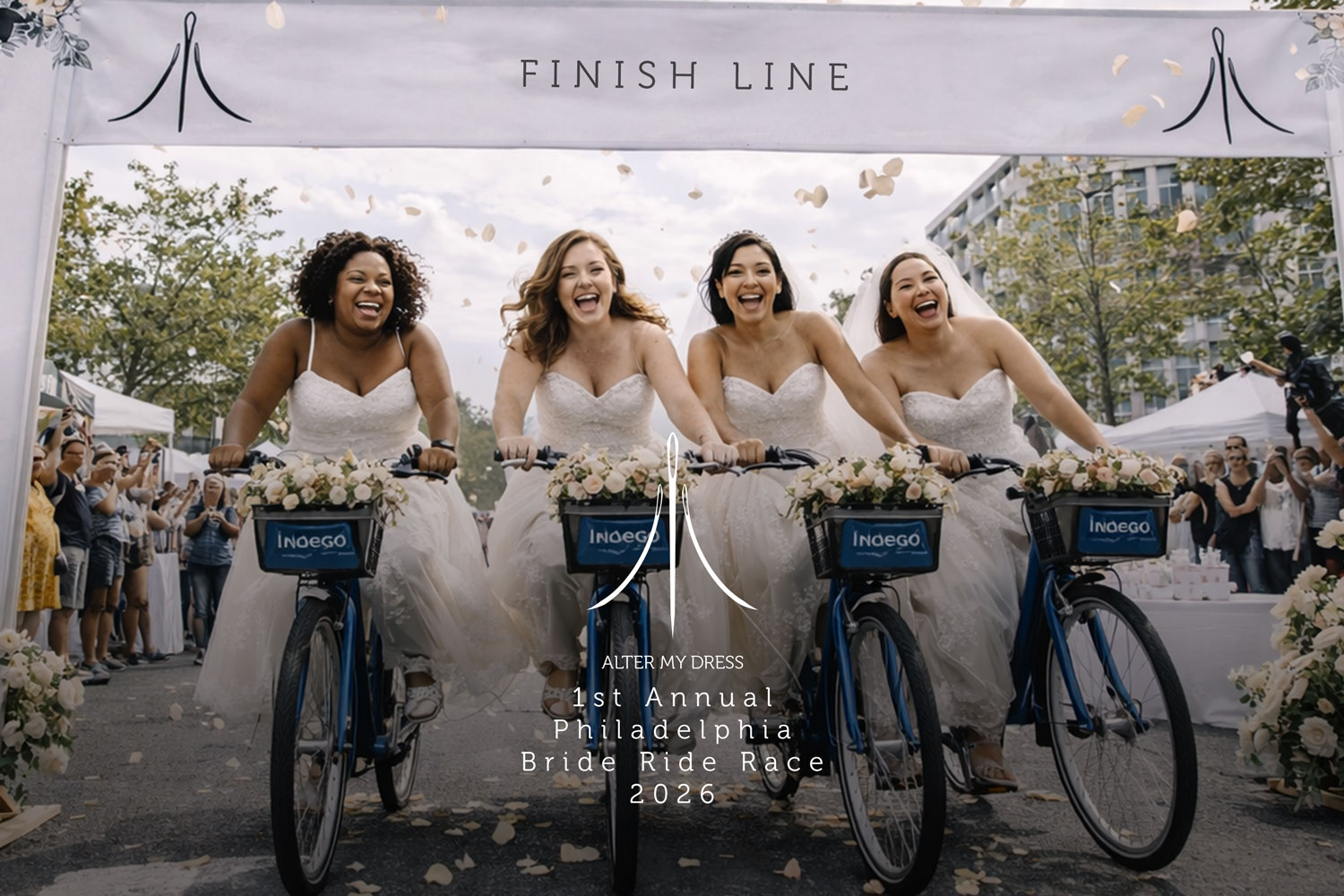 Four brides in wedding dresses riding decorated bikes under a finish line banner in the 1st Annual Philadelphia Bride Ride Race 2026.