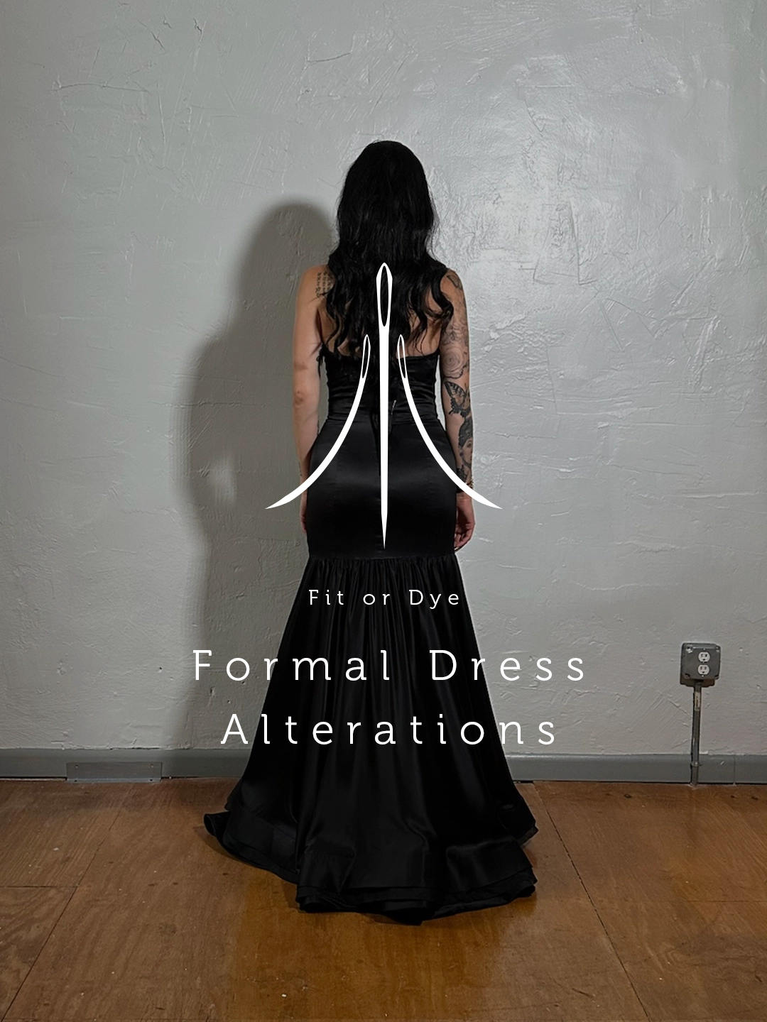 Back view of a woman in a black formal dress standing facing the wall in a studio setting. Logo and overlay text Formal Dress Alterations.