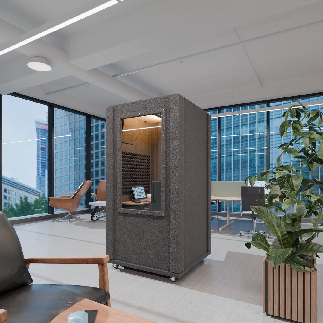 Office Booth on casters in a high-rise open office, a desk and laptop visible through its large wall window