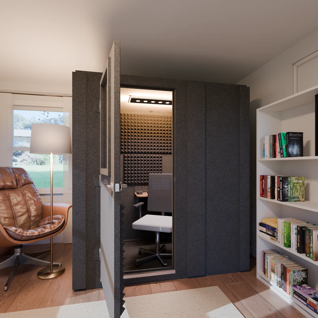 Work From Home Booth open in a home study beside a leather lounge chair and bookshelf, a desk and office chair inside