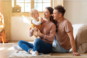 image of a young couple holding their baby