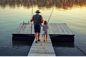 John Hancock 2026 Long Term Care Awareness Longevity Preparedness Report - a grandfather walking down a dock with his young granddaughter with fising poles.