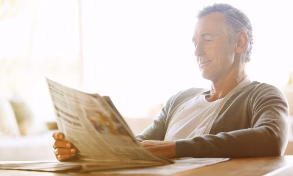 Man reading newspaper.