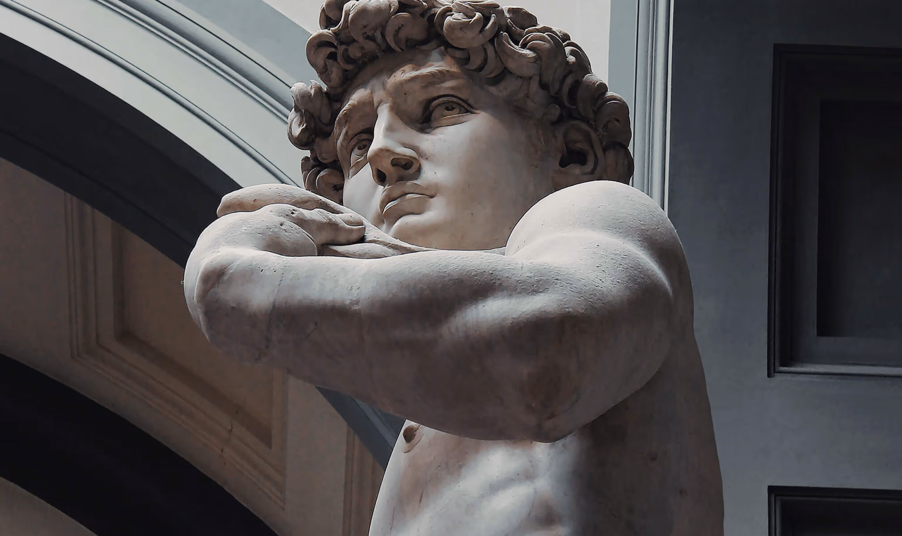 Sculpture of David in Florence from lower angle focused on his face.