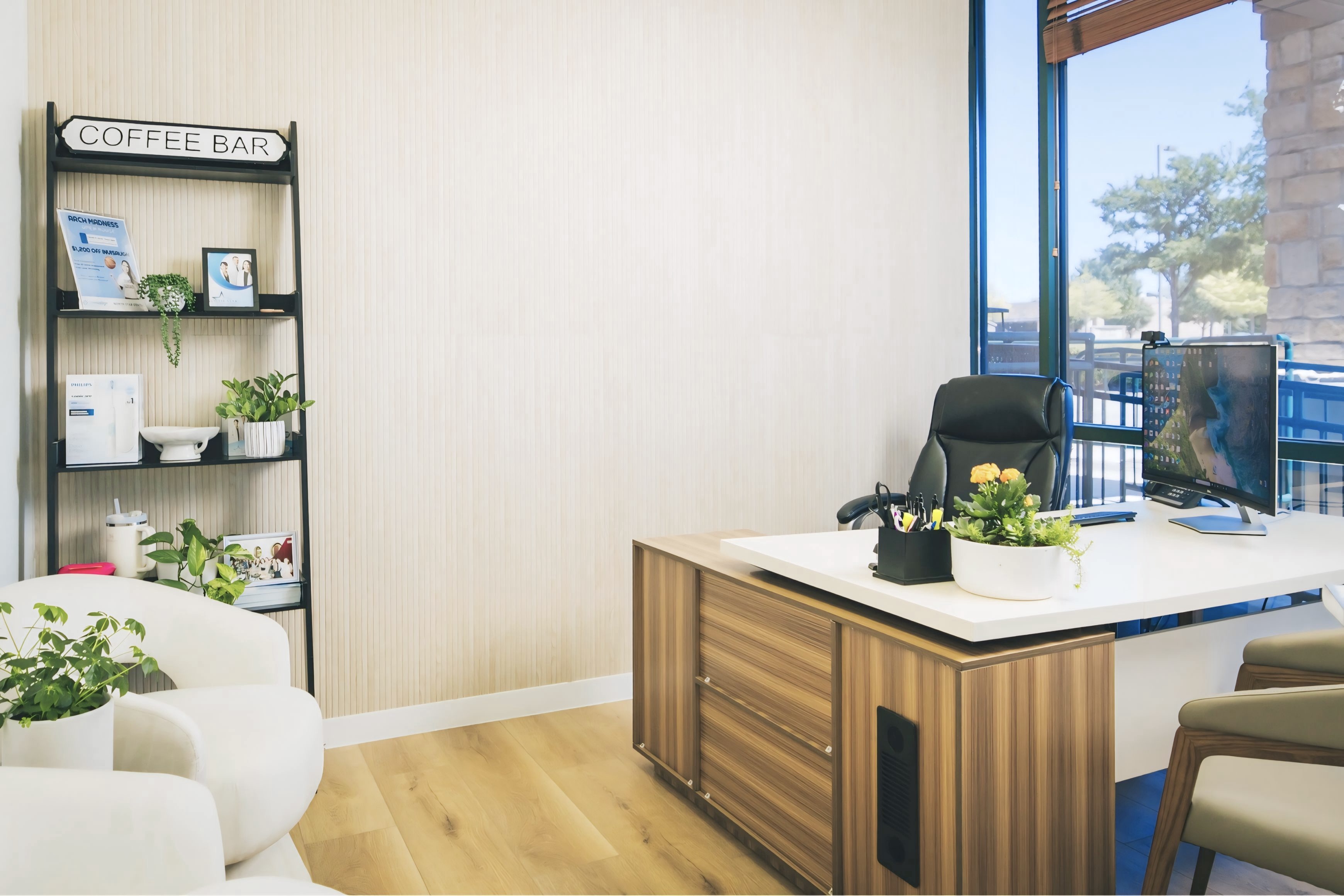 A room with a desk, chairs, and a window.