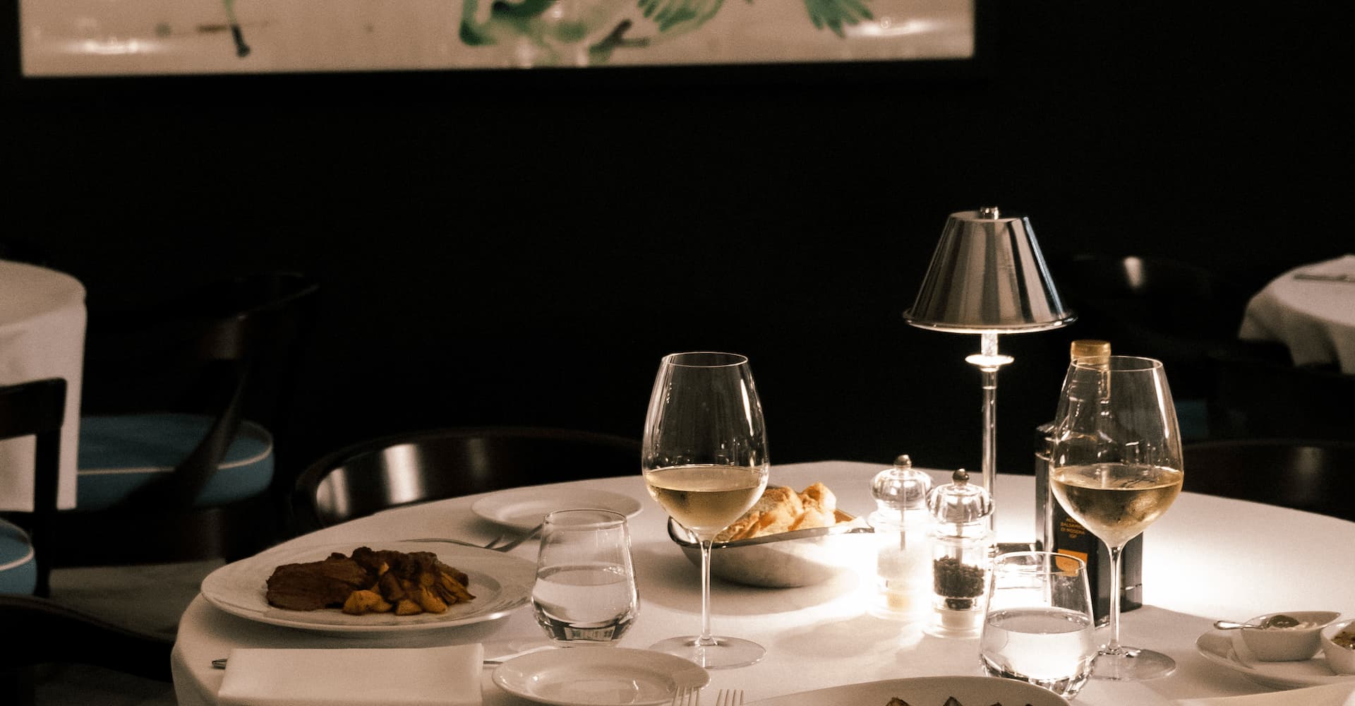 Fine dining table with gourmet dishes and wine at Hotel La Serena.