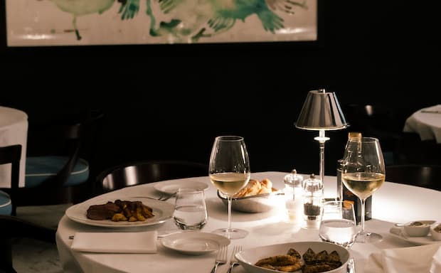 Fine dining table with gourmet dishes and wine at Hotel La Serena.