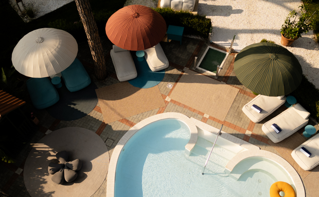 Aerial view of pool with colorful umbrellas and lounge chairs at La Serena.