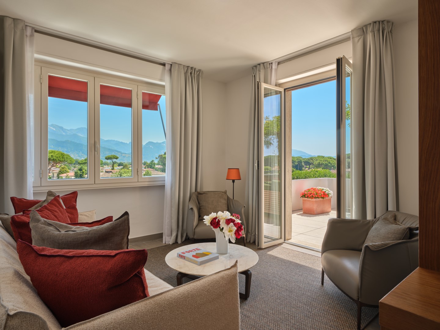 Spacious luxury suite with elegant decor, a king-sized bed, and modern amenities.
