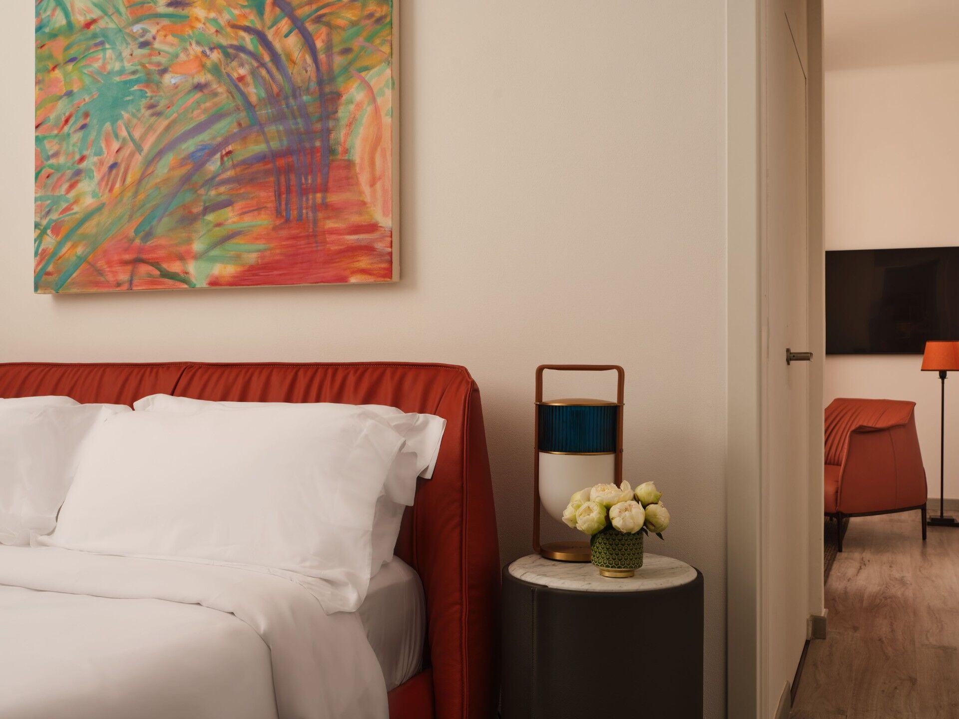 Spacious luxury hotel room with elegant decor.