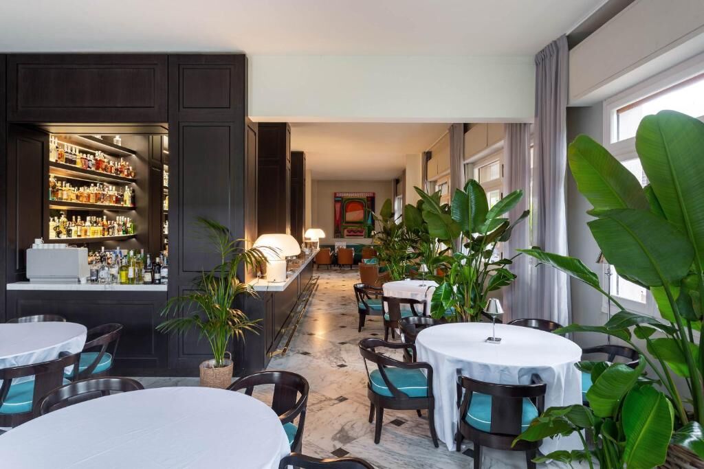 Spacious restaurant interior featuring stylish decor and a warm, inviting atmosphere.