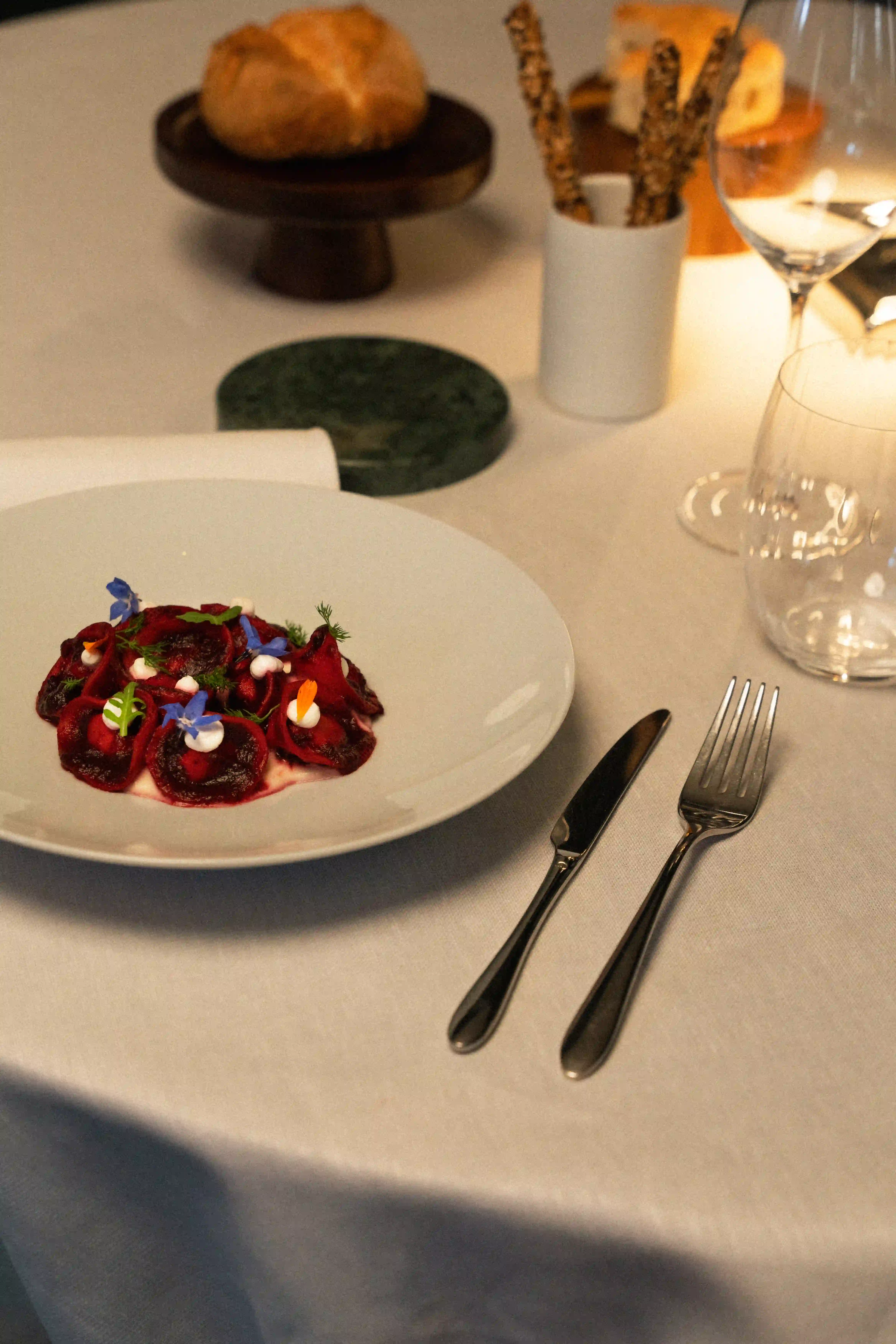 Elegant restaurant dining room with neatly arranged tables and soft ambient lighting.