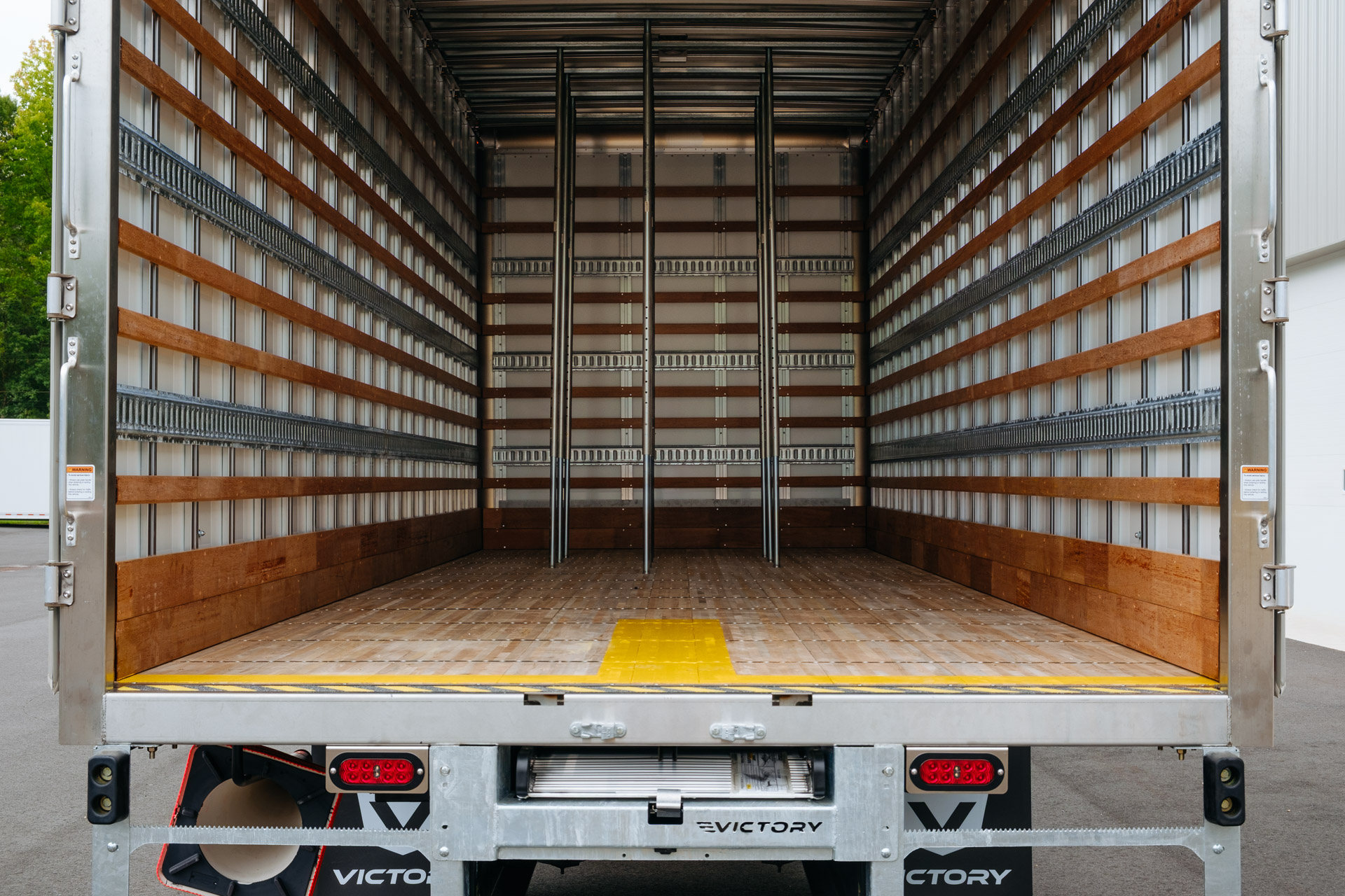 The inside of a truck body with wood slats, E Series track, F-Series track 