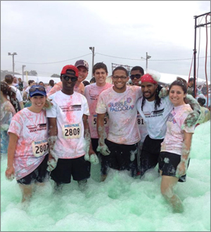 Parts Life, Inc. staff and summer interns pause knee-deep in bubbles