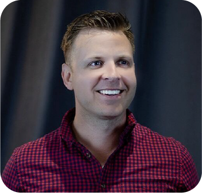 A diverse group of musicians and singers performing on a stage, with a woman singing into a microphone and a guitarist playing beside her.