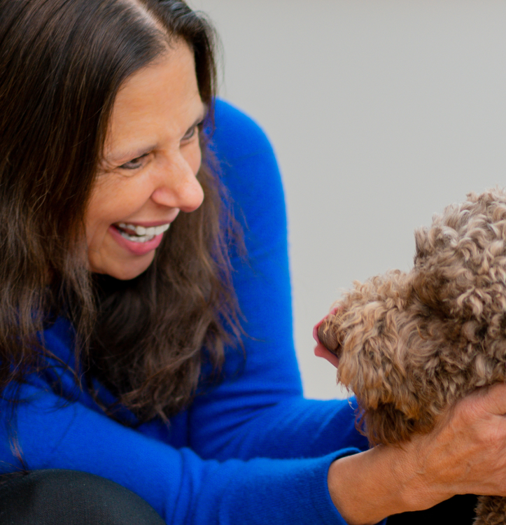 Laurie Branch, CEO and President of Ironpeak, smiles as she pets one of her dogs.