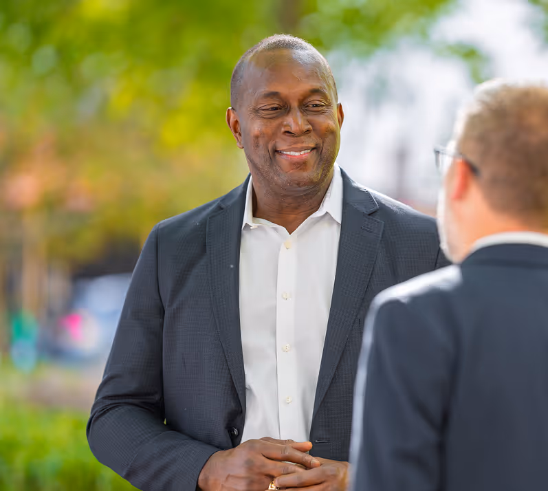 Two male Ironpeak regional managers share a conversation outdoors. 