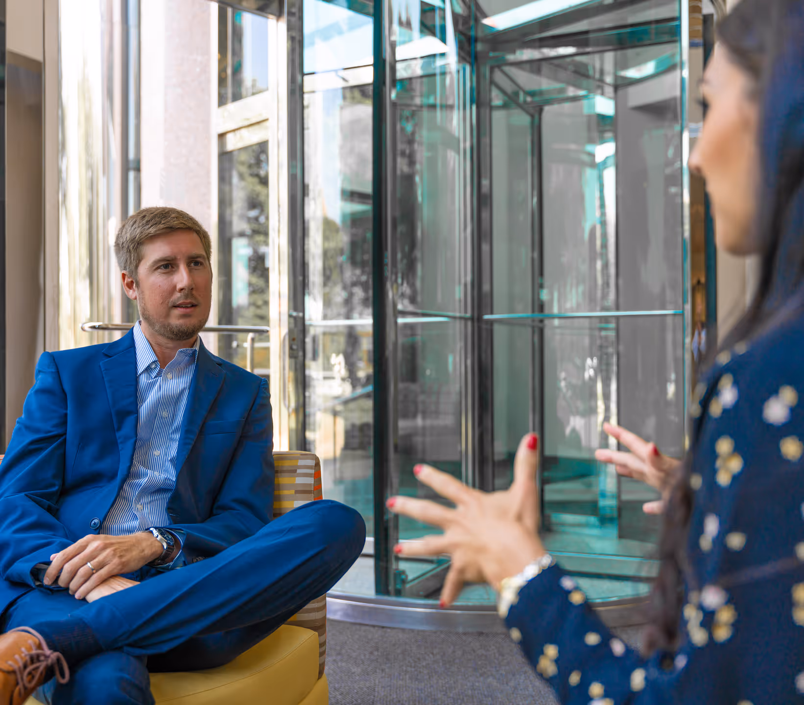 A regional manager meets with an Ironpeak Member Agency principal in the lobby of the agency building.