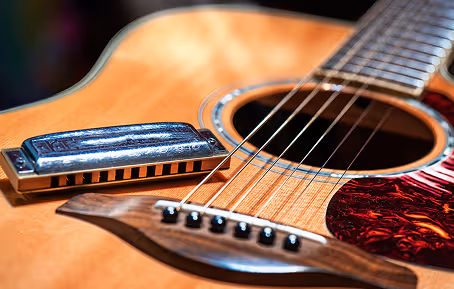 A guitar and harmonica signify how important music is from Nashville to New Orleans in the South Region. 