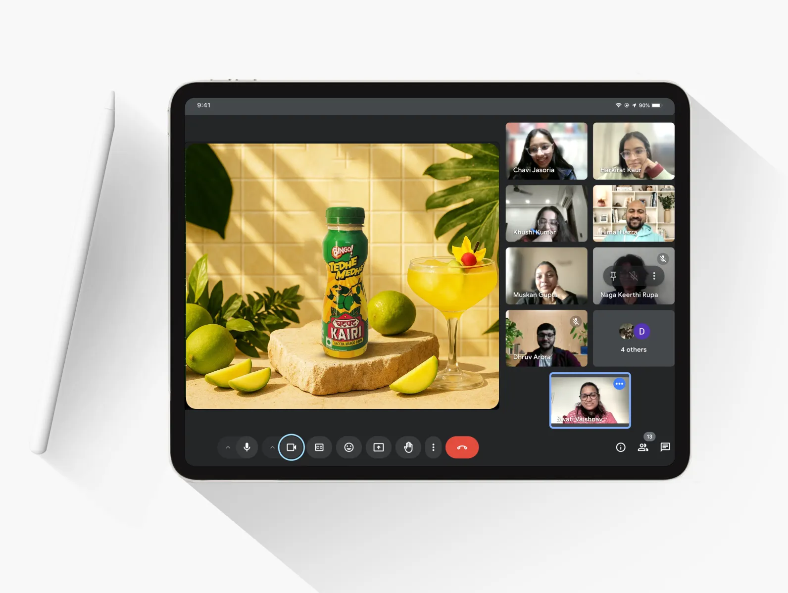 Tablet displaying a video call with a product photograph of 'Real Aam Panna' and employees participating in the call.