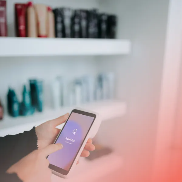 Person using a smartphone with the Vocale Pay app open on the screen.