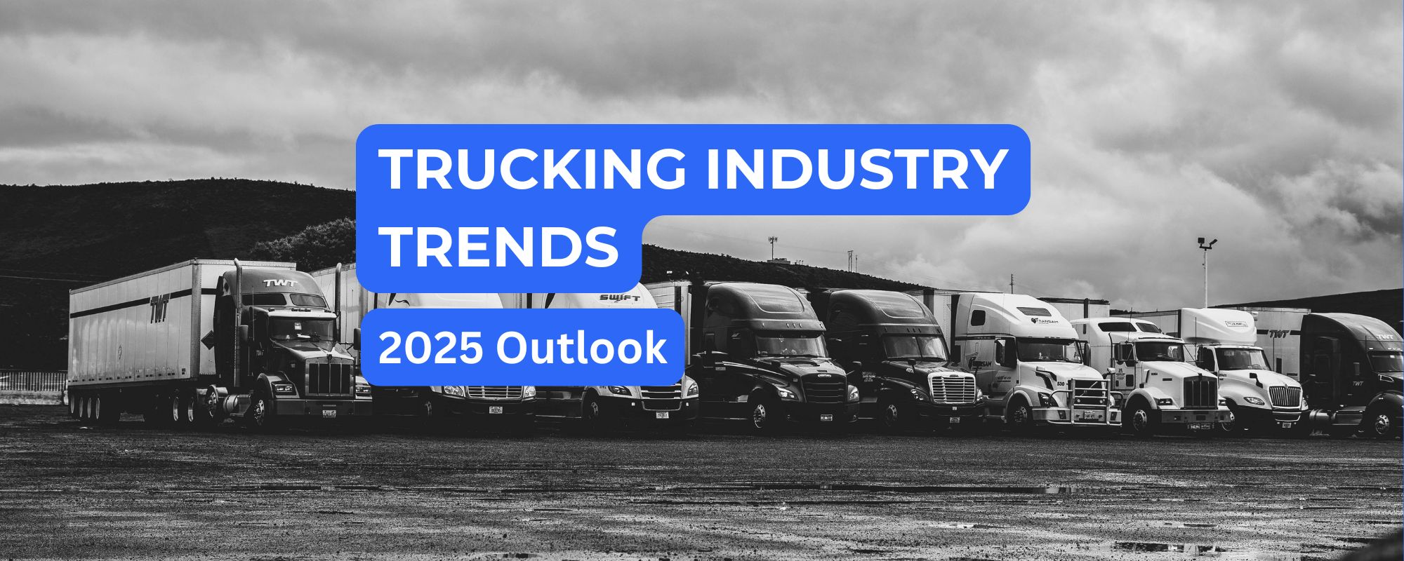 Black-and-white photo of semi-trucks parked in a row for fleet industry trends