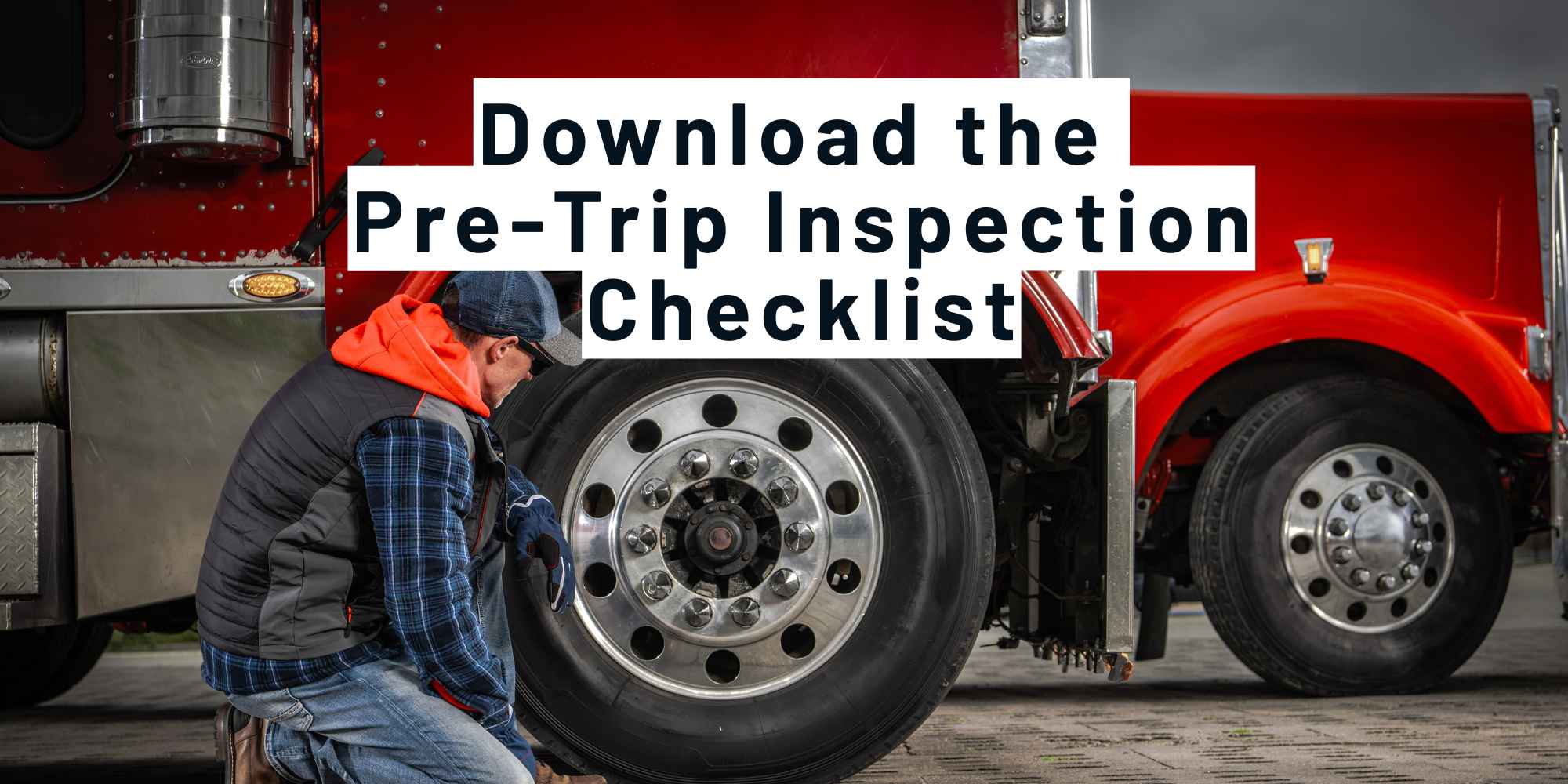 Truck driver kneeling to check a semi truck tire during a pre-trip inspection, with the text Download the Pre-Trip Inspection Checklist