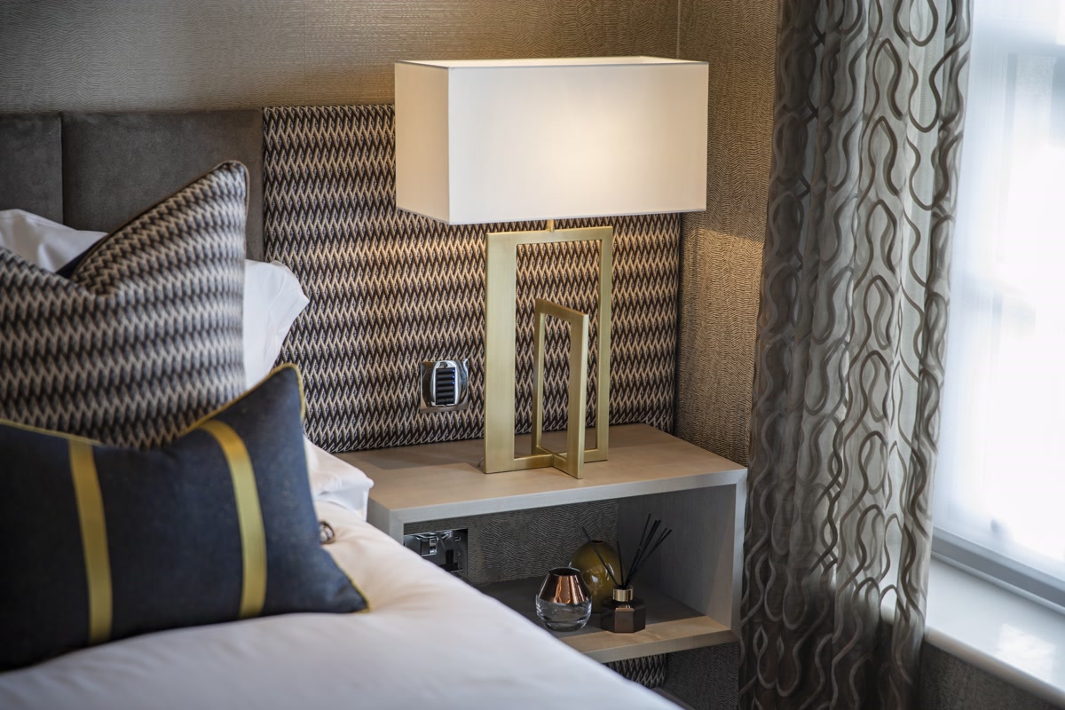 Inside of a living room with 3 couches around a table