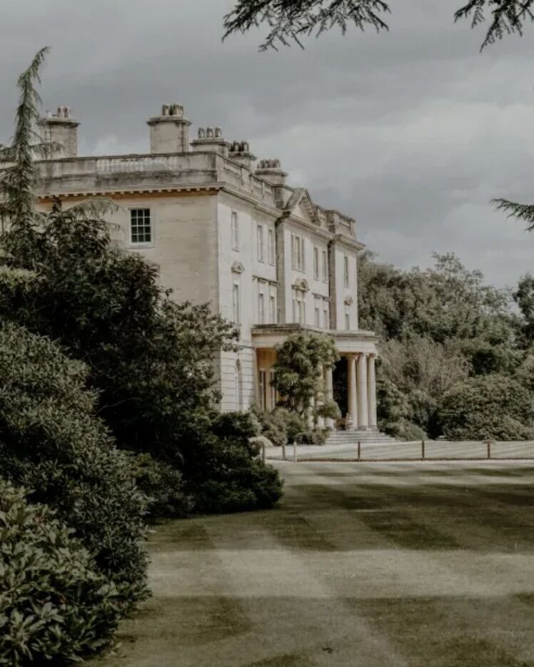 Outside of a listed building with a large lawn