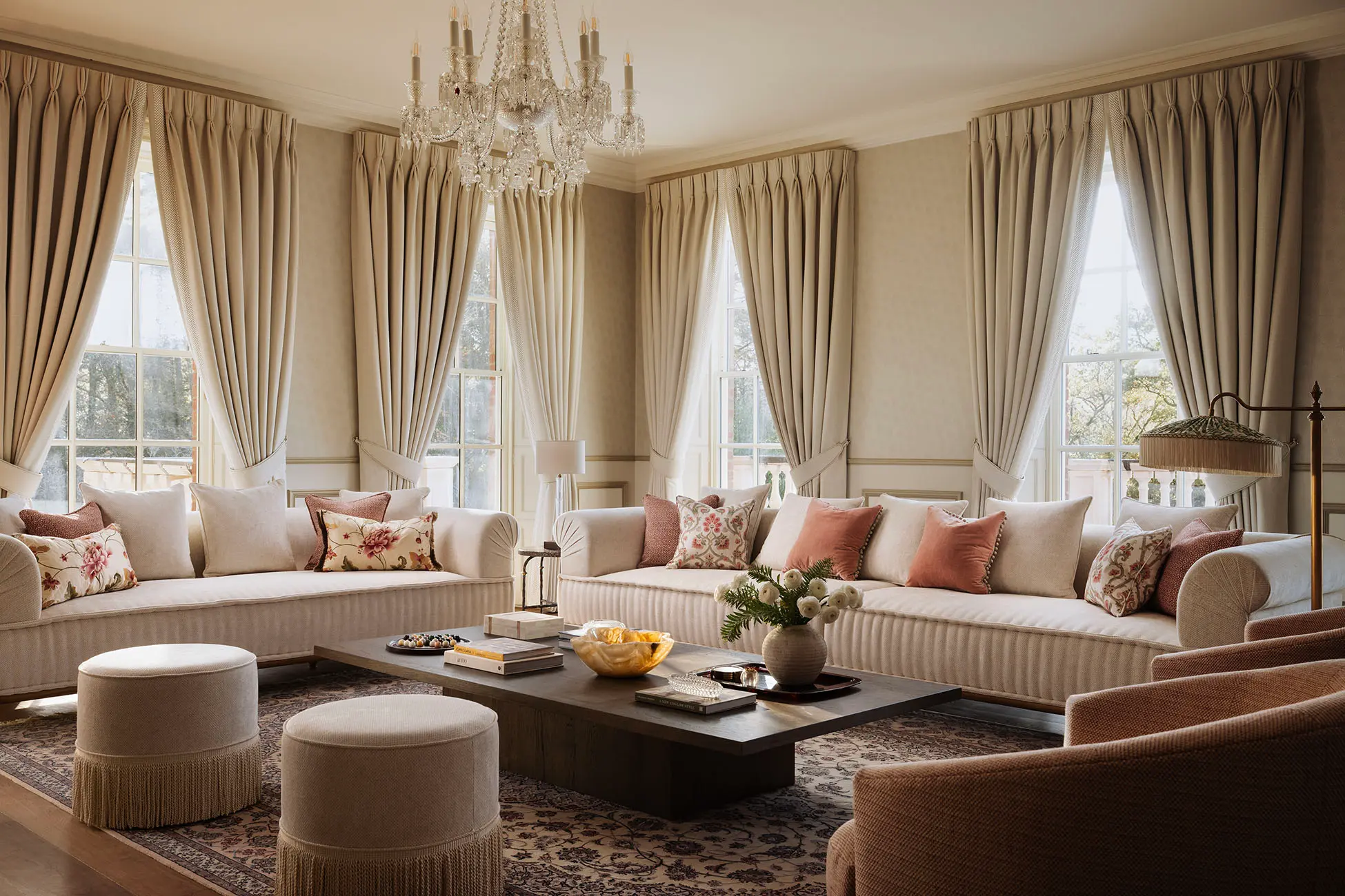 Inside of a living room with 3 couches around a table