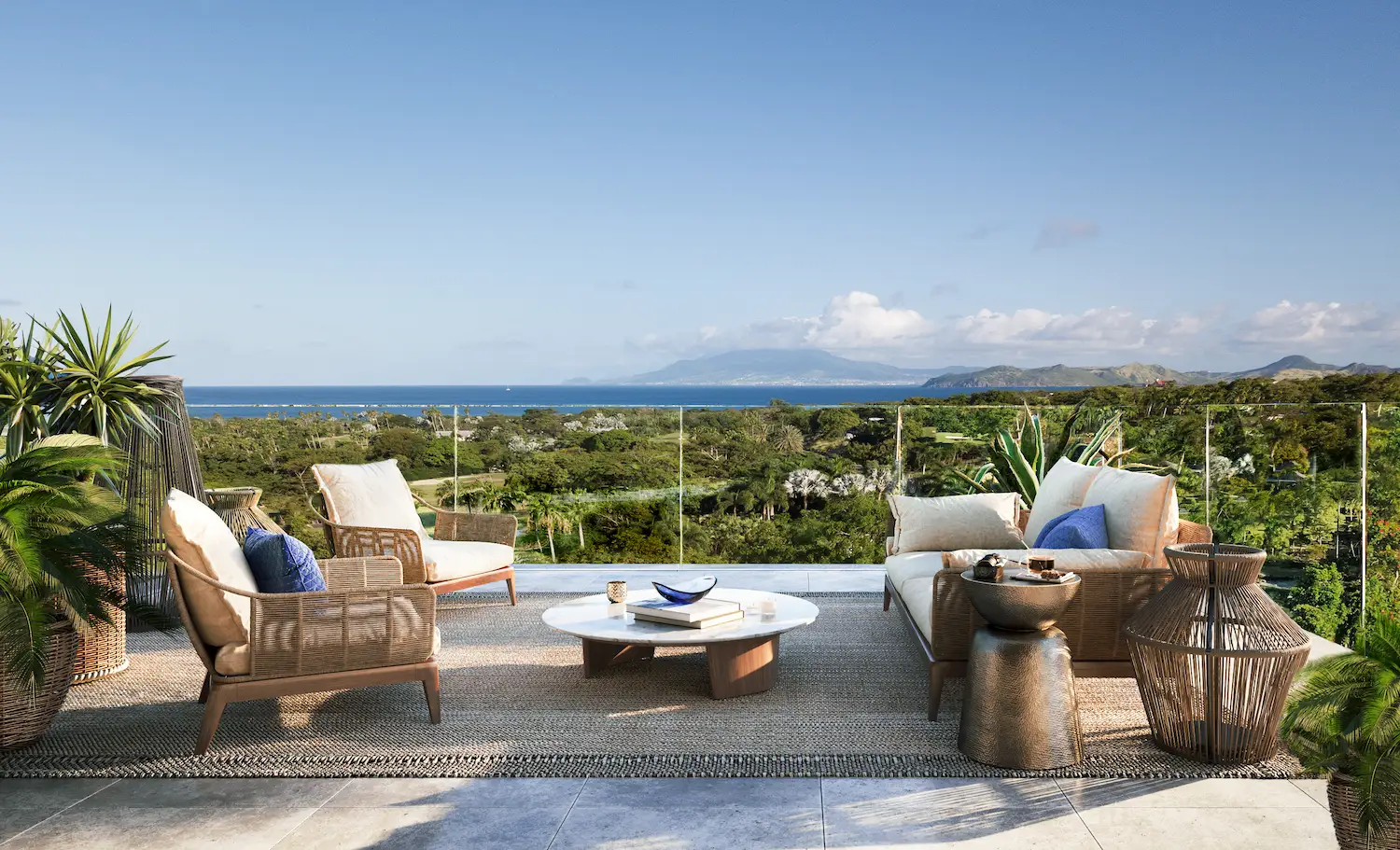Rooftop terrace lounge seating overlooking Nevis's coastline and mountains at Four Seasons Nevis Peak Residences