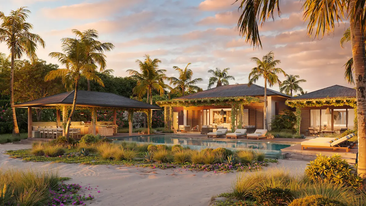 Pool and pergola-covered terrace beside the beach at dusk, with palm trees and softly lit interiors at Nobu Residence, Barbuda