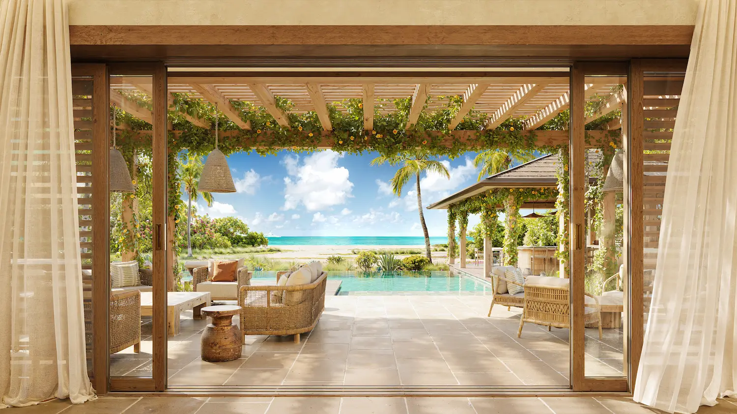 Rattan lounge seating opening through sliding glass doors onto a beachfront pergola terrace at Nobu Residence, Barbuda