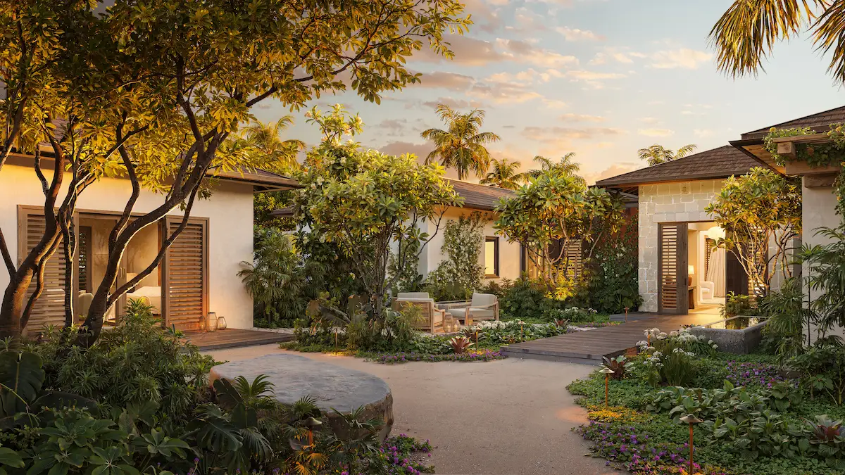 Twilight view of the residence courtyard with lit pathways and lush tropical planting at Nobu Residence, Barbuda