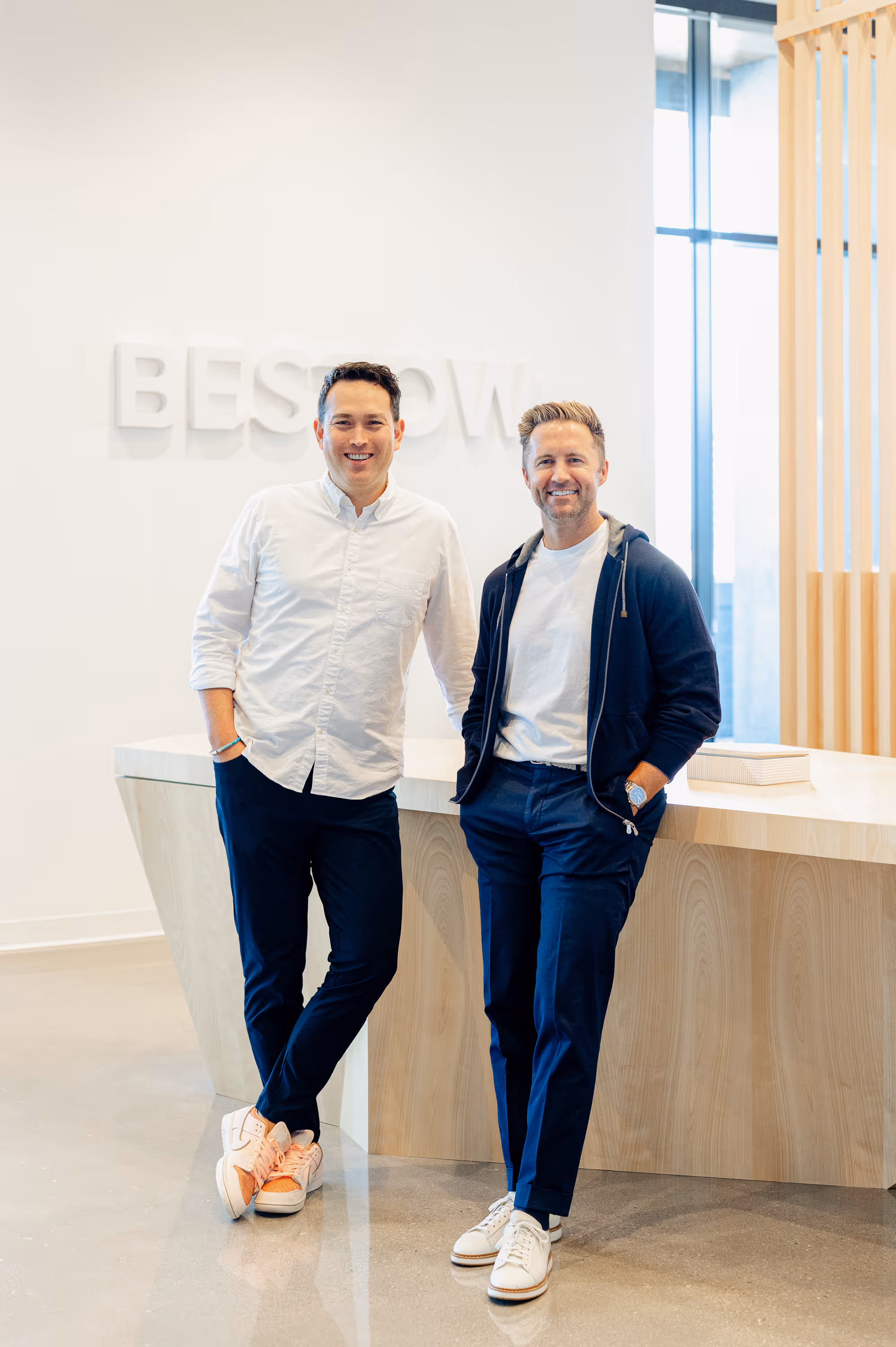 2 men smiling at the camera